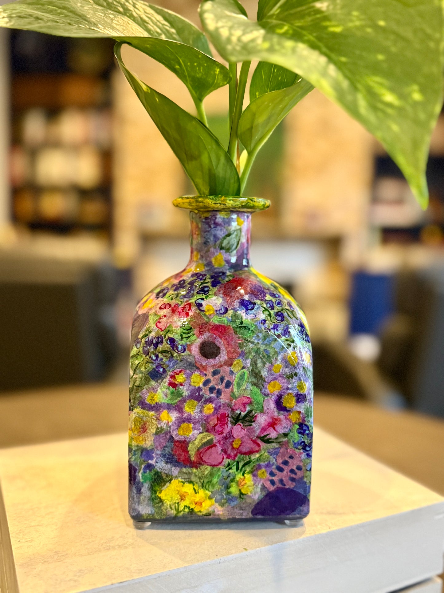 Maximalist style repurposed tequila bottle flower vase