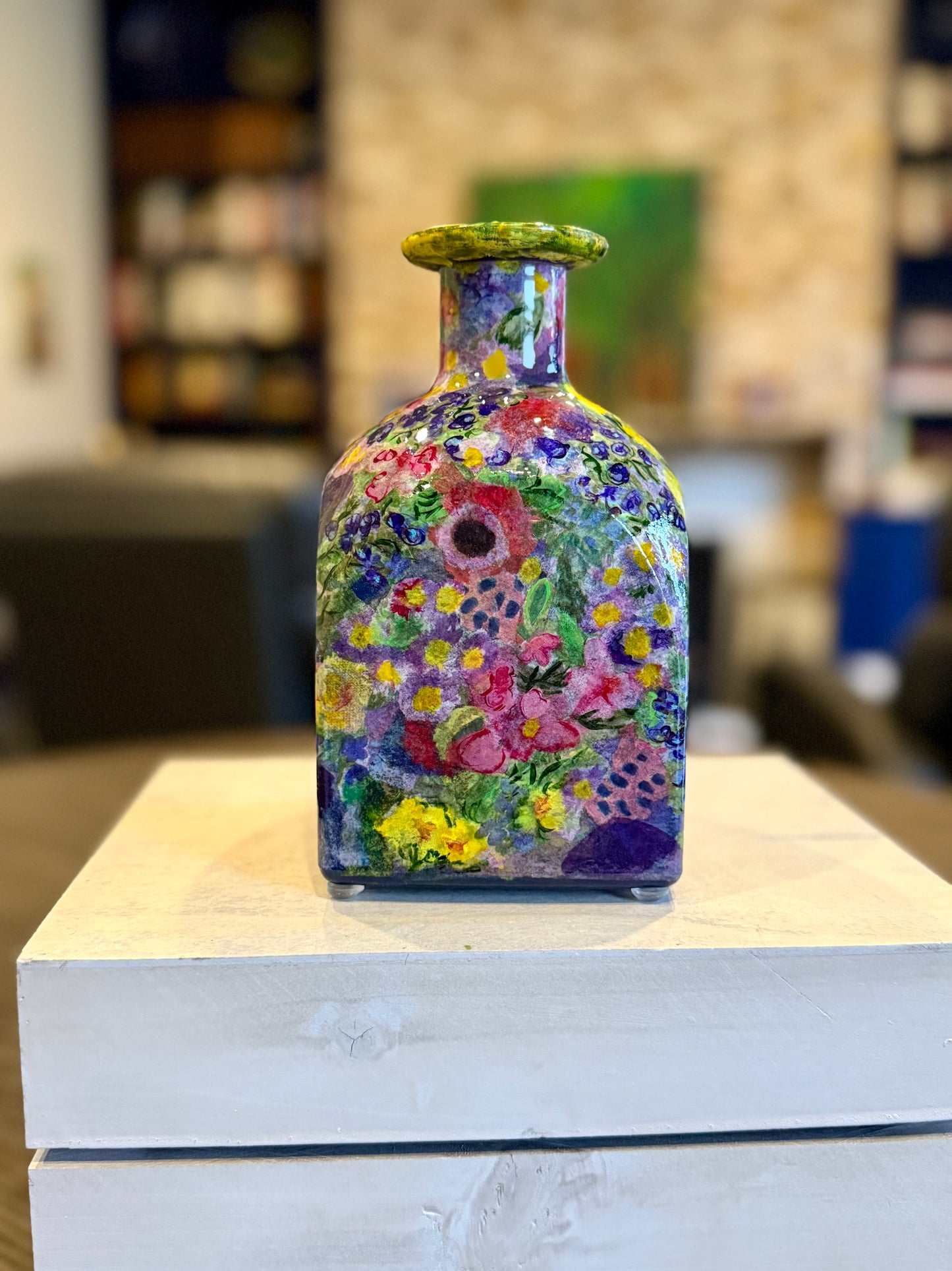 Maximalist style repurposed tequila bottle flower vase